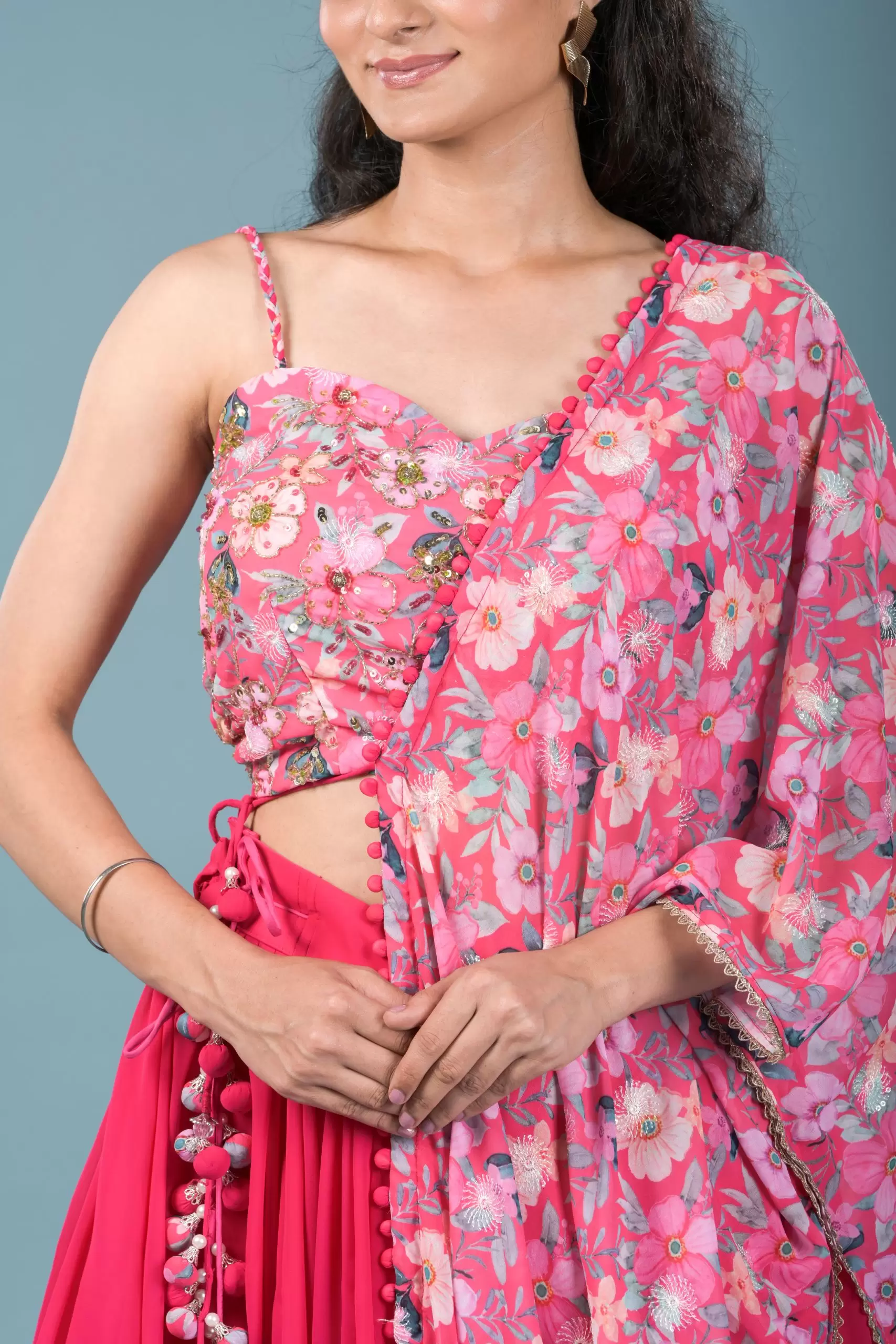 Gulnar Flared Lehenga and Blouse set with Shrug style Dupatta and Tassel Detailings.