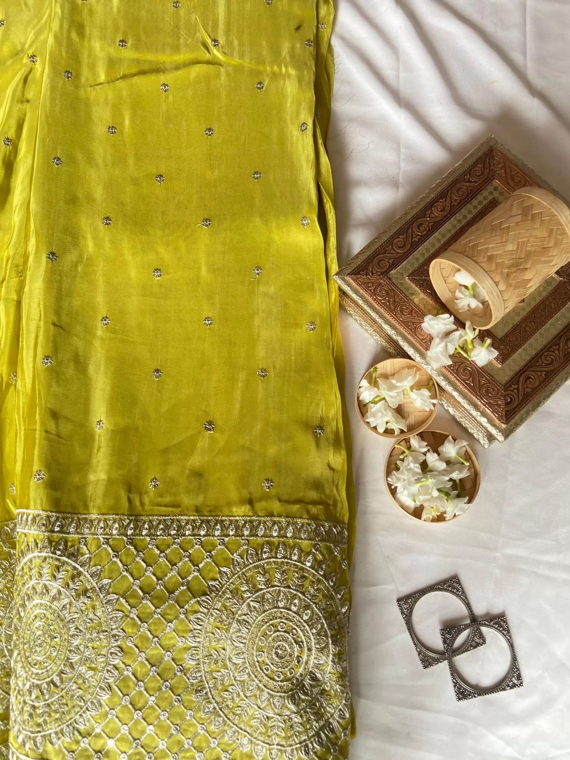 Crepe silk parrot green buti work fabric with heavy zari and sequin embroidered border