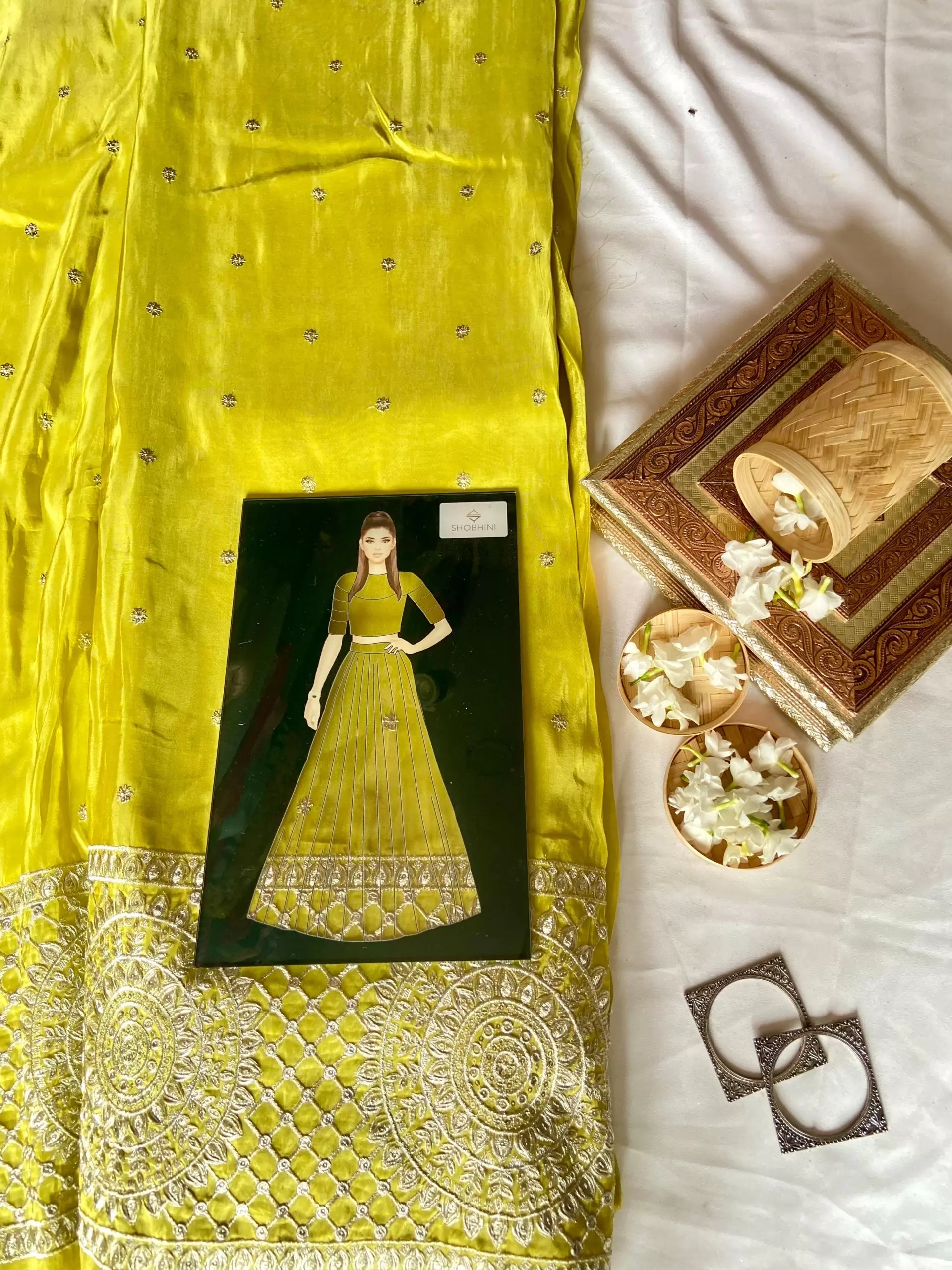 Crepe silk parrot green buti work fabric with heavy zari and sequin embroidered border