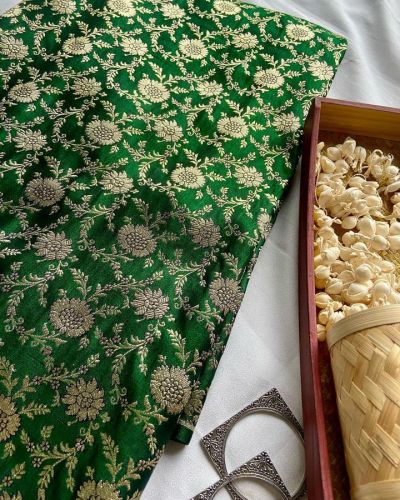 Golden floral motifs on green banarasi fabric