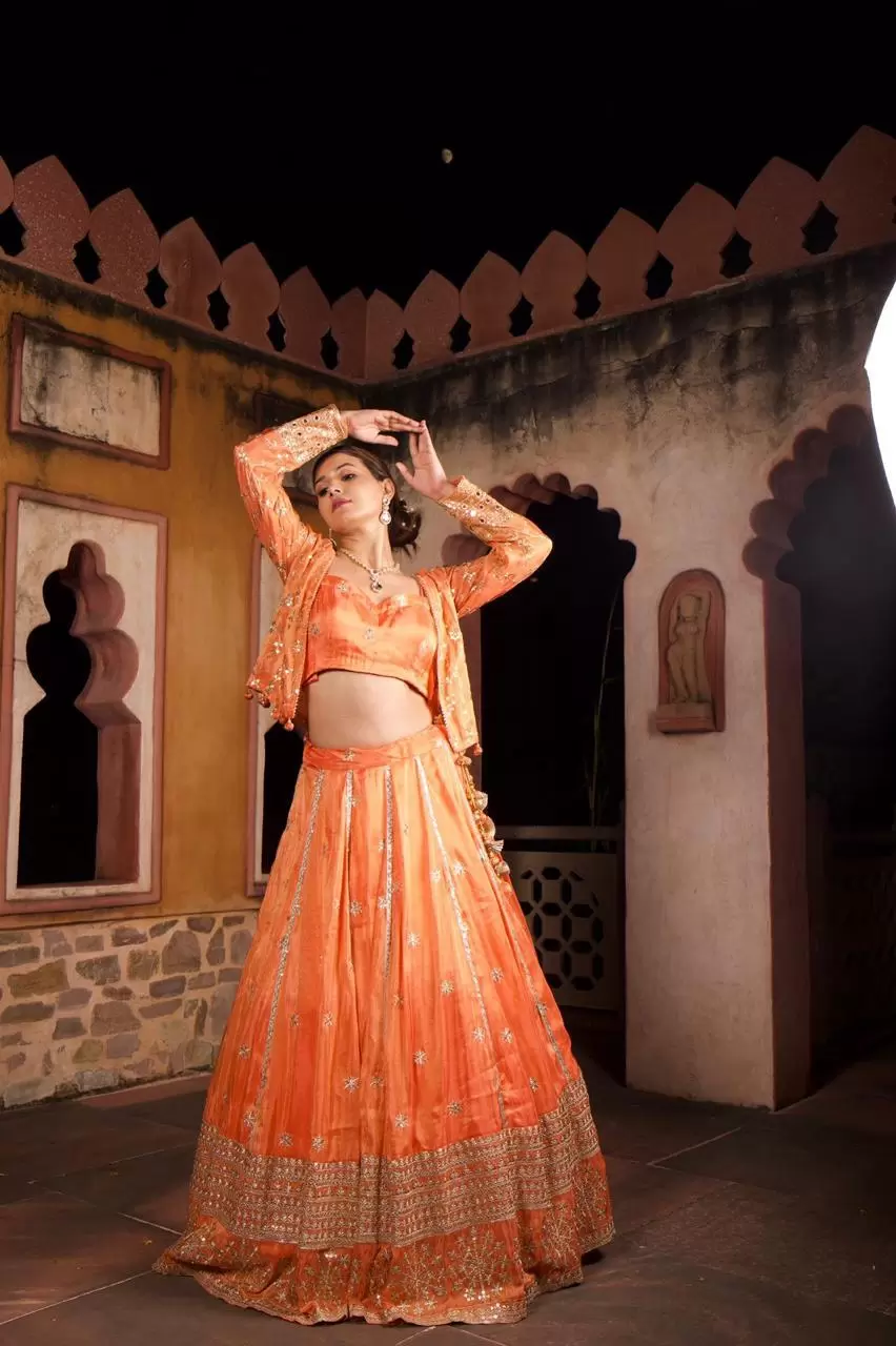 Rust orange pure cosmos tissue silk lehenga with heavy Embroidered jacket