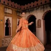 Rust orange pure cosmos tissue silk lehenga with heavy Embroidered jacket