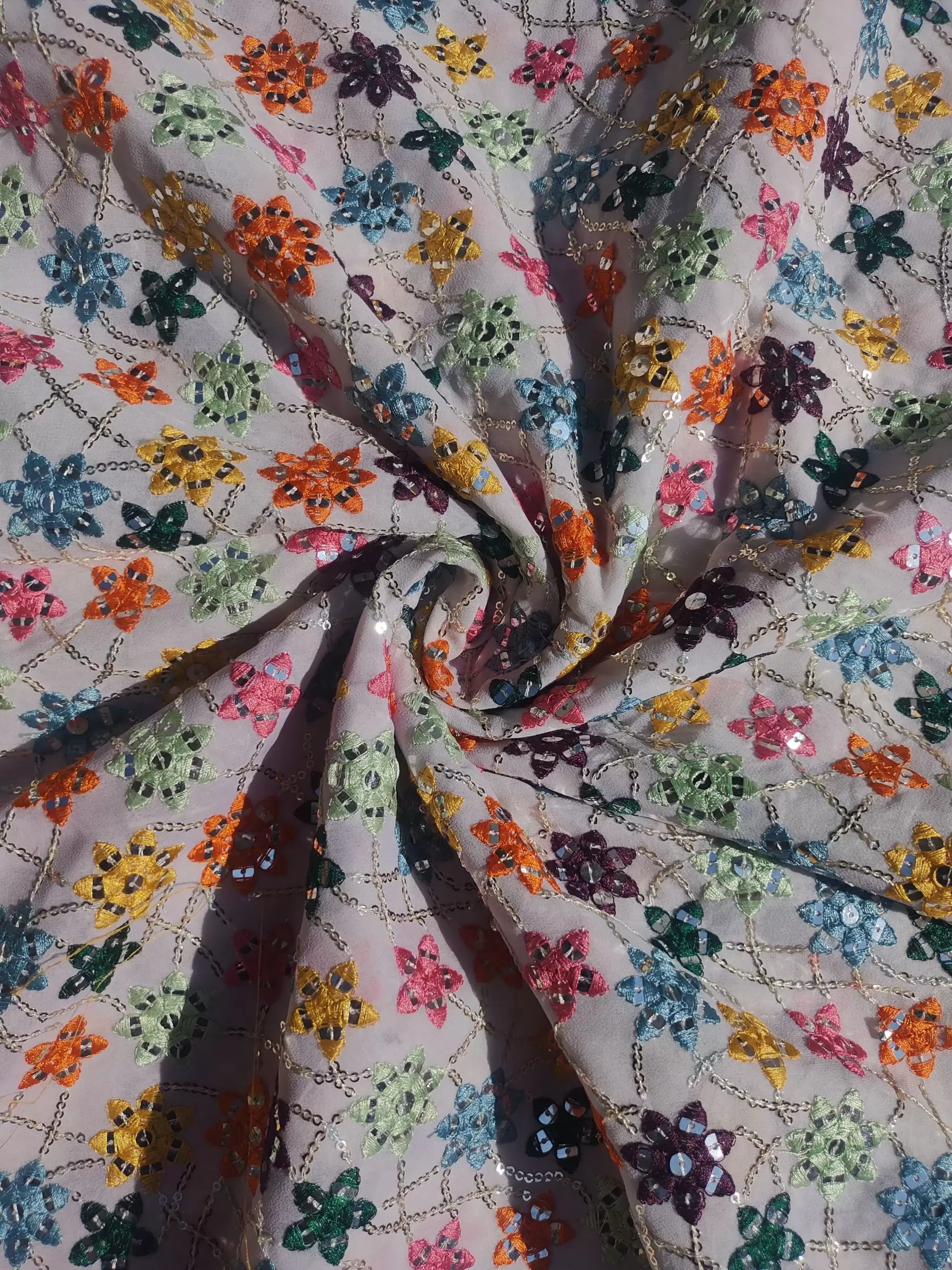 Multi colour faux mirror like sequin embroidery in floral pattern on poly Georgette White fabric