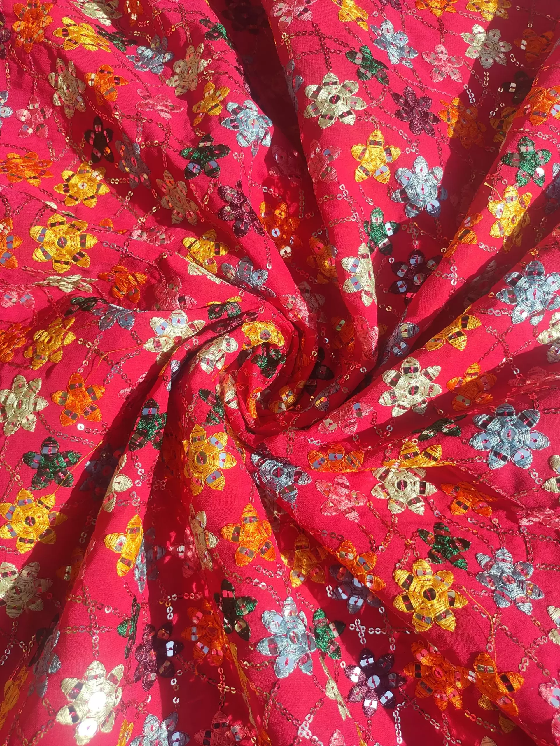 Multi colour faux mirror like sequin embroidery in floral pattern on poly Georgette Rani Pink fabric