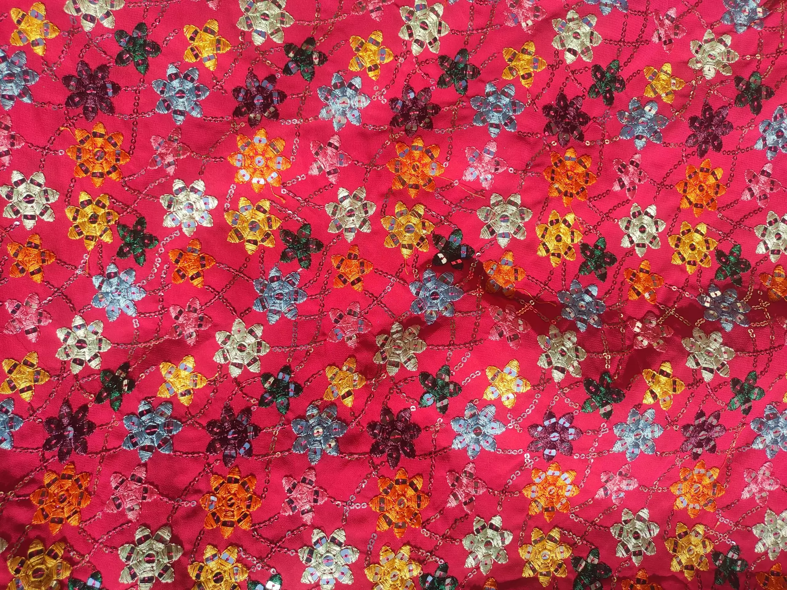 Multi colour faux mirror like sequin embroidery in floral pattern on poly Georgette Rani Pink fabric
