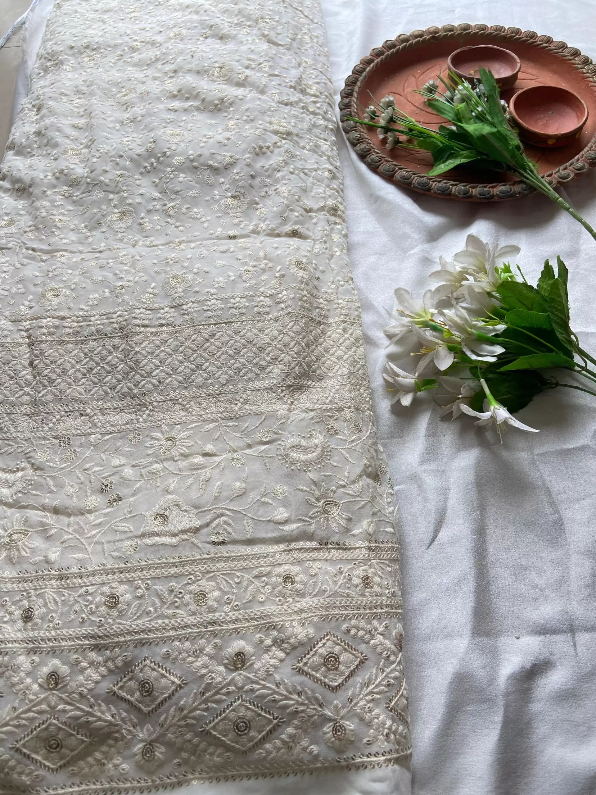 Gold zari embroidery with heavy border on white georgette fabric