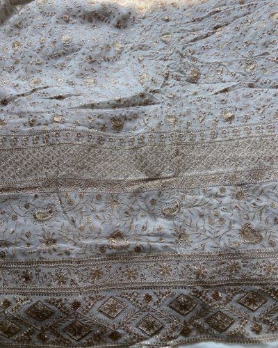 Gold zari embroidery with heavy border on white georgette fabric