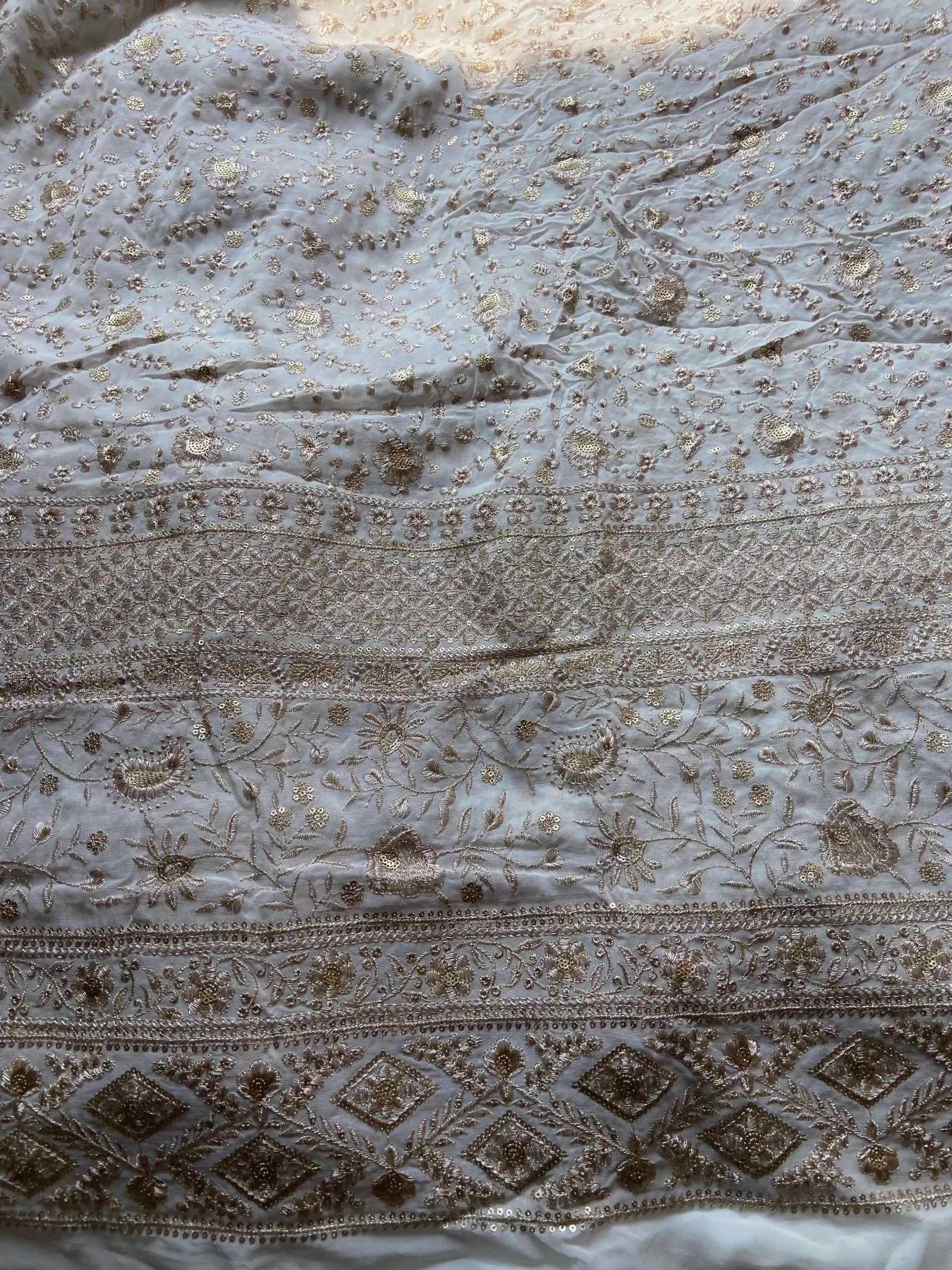 Gold zari embroidery with heavy border on white georgette fabric