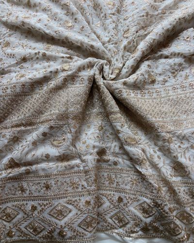 Gold zari embroidery with heavy border on white georgette fabric