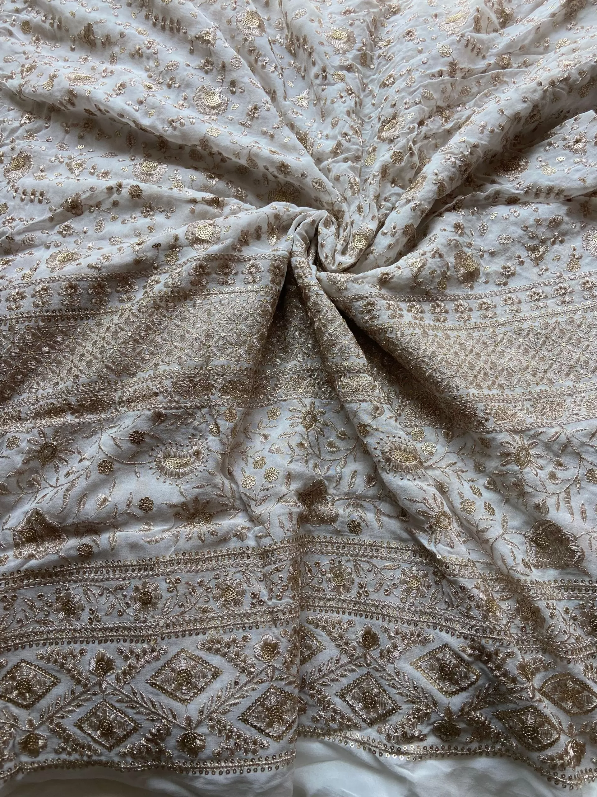 Gold zari embroidery with heavy border on white georgette fabric