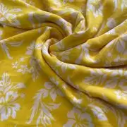 Yellow printed georgette fabric with white floral pattern