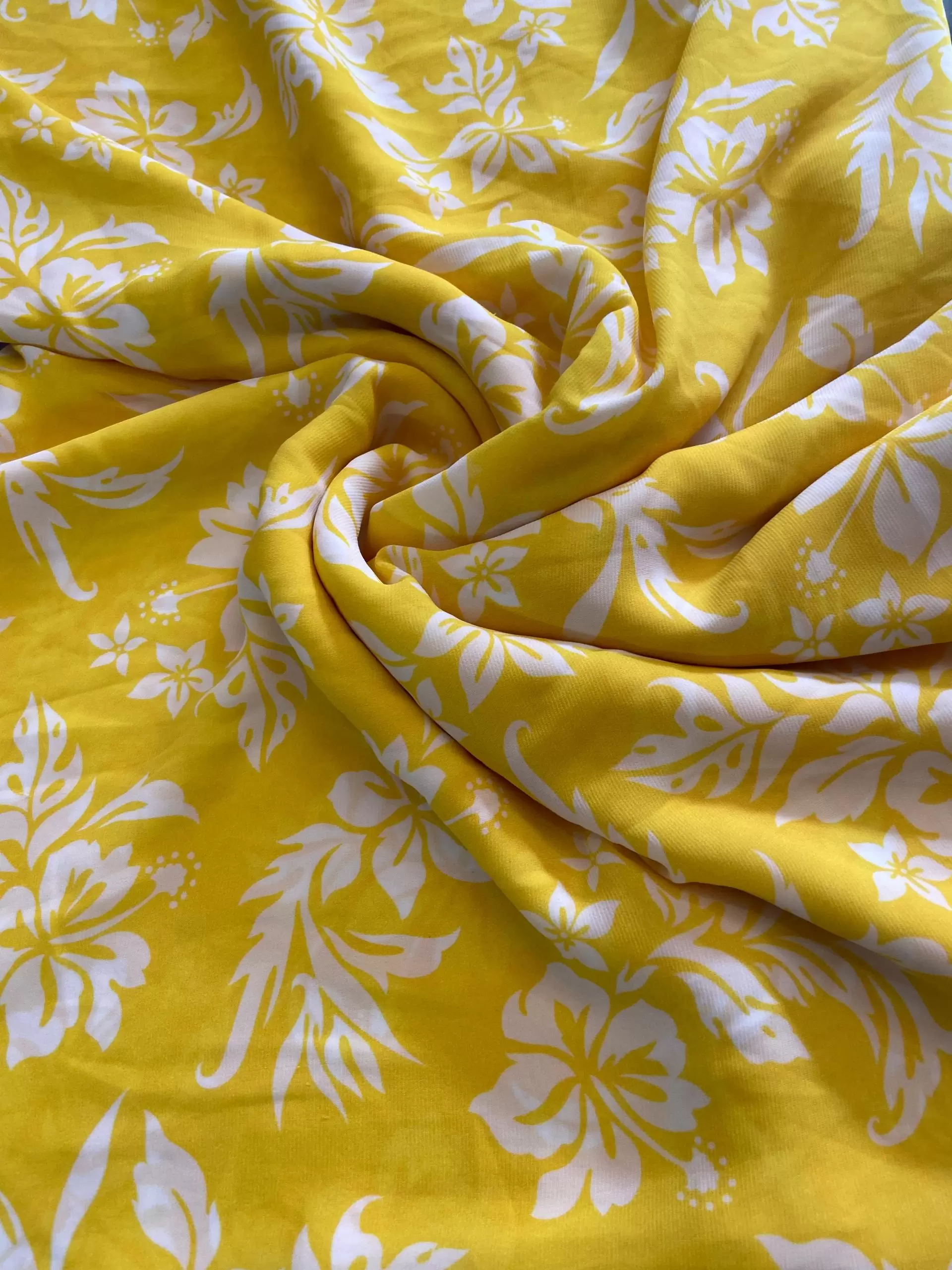 Yellow printed georgette fabric with white floral pattern