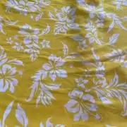 Yellow printed georgette fabric with white floral pattern