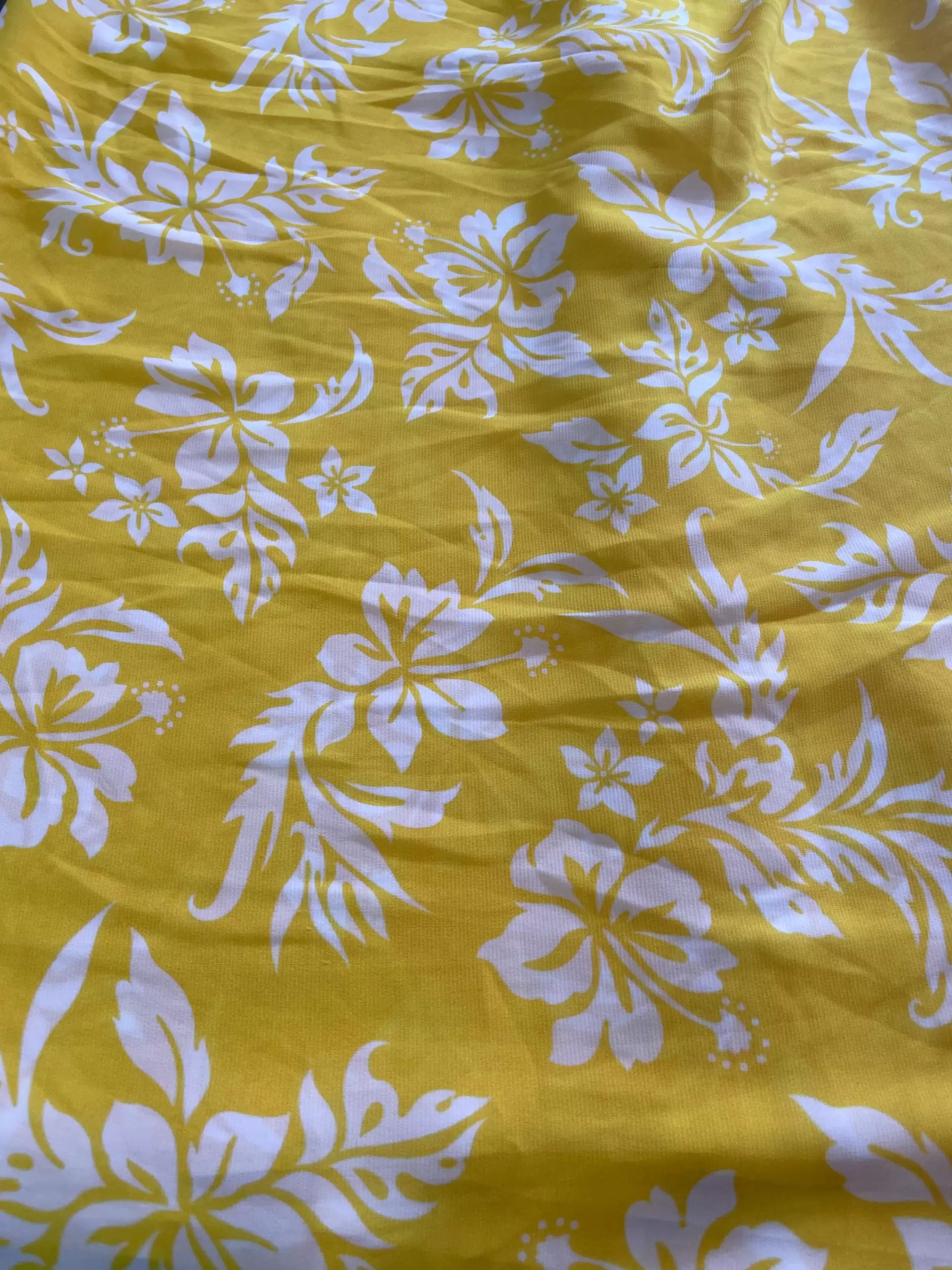 Yellow printed georgette fabric with white floral pattern