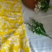 Yellow printed georgette fabric with white floral pattern