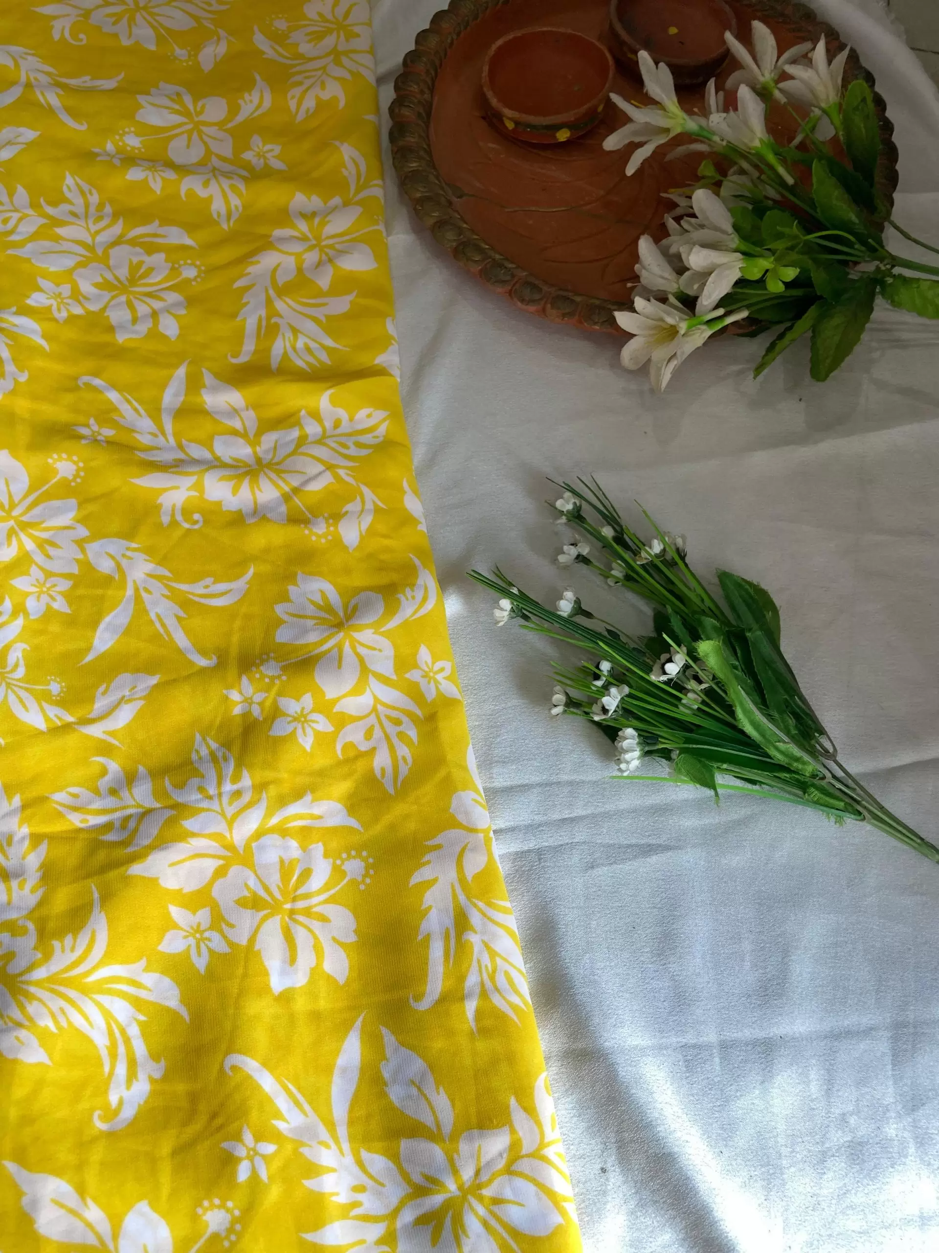 Yellow printed georgette fabric with white floral pattern