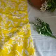 Yellow printed georgette fabric with white floral pattern