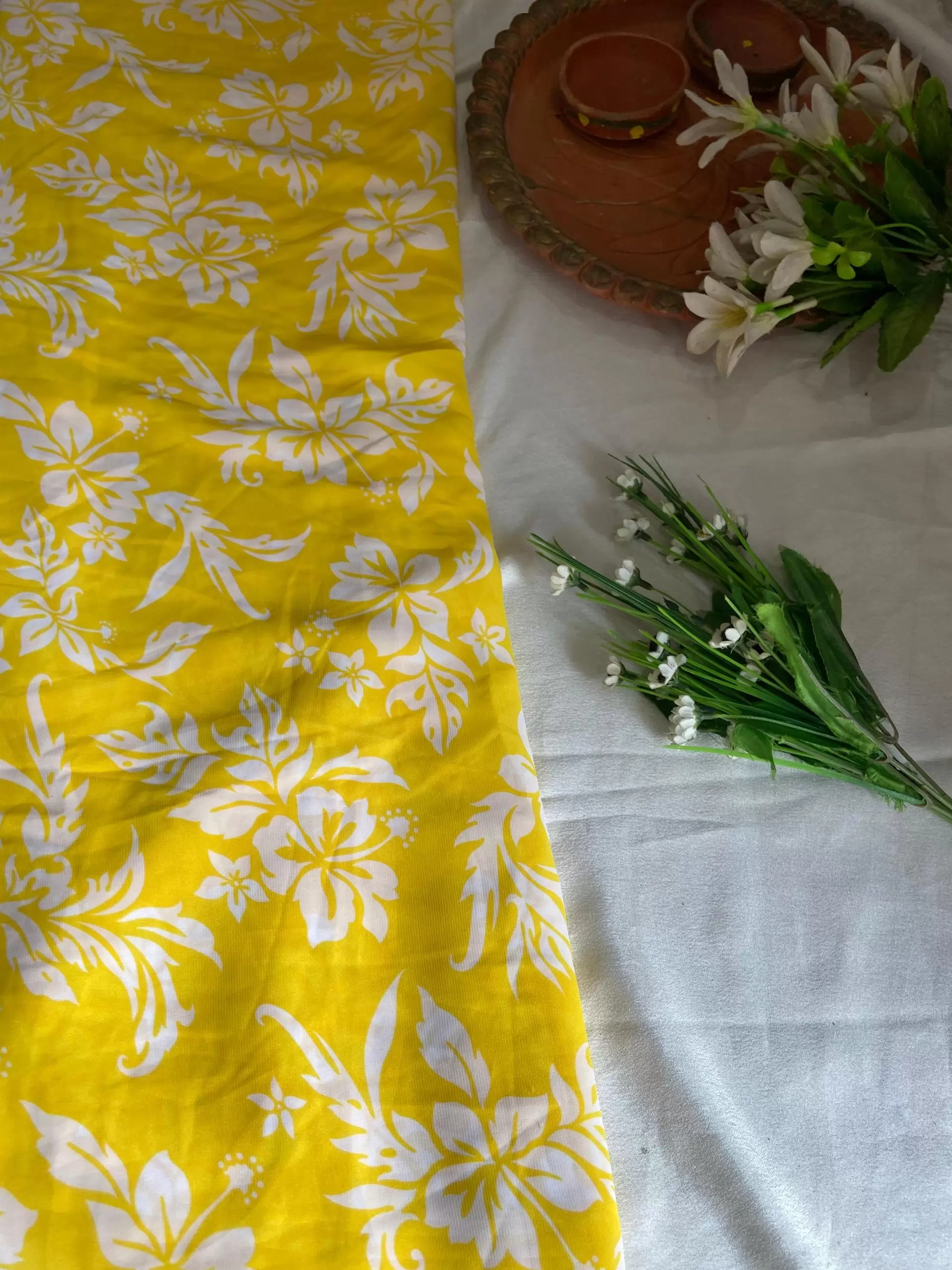 Yellow printed georgette fabric with white floral pattern